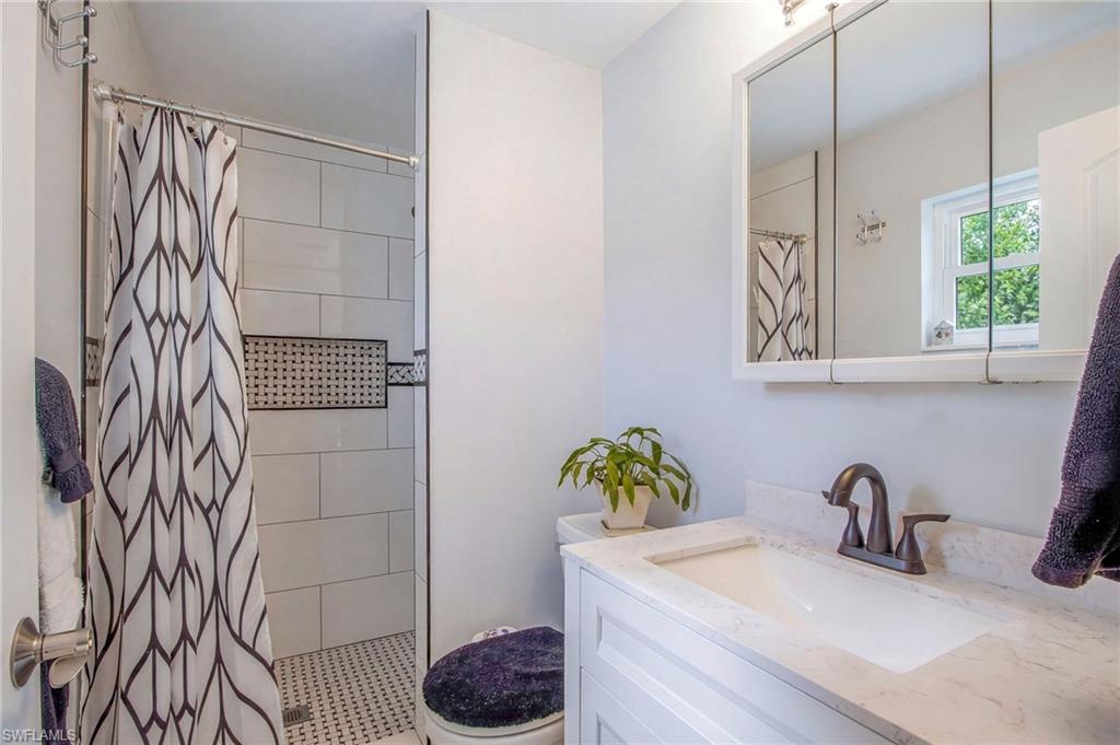 Bathroom with a stall shower and vanity