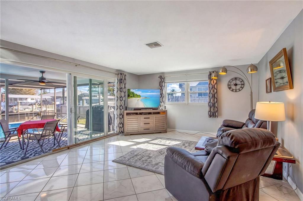Living room featuring baseboards and a ceiling fan