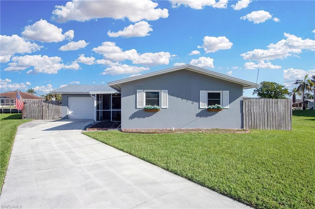 Ranch-style home featuring driveway, stucco siding, and a garage