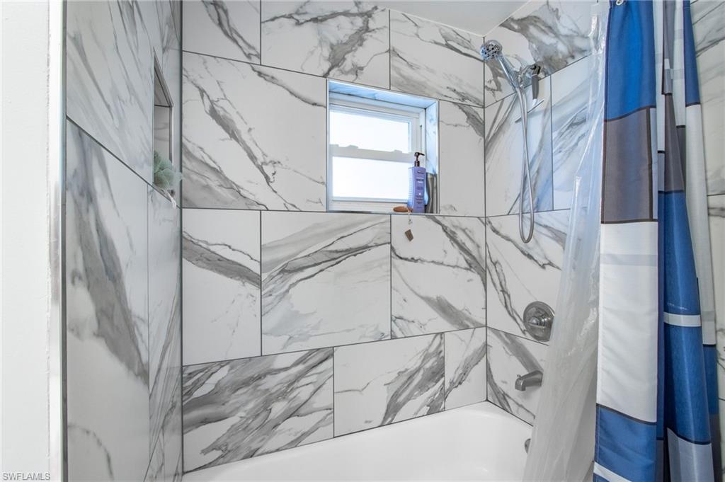 Full bathroom with shower / tub combo with curtain