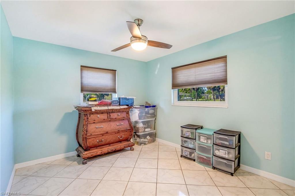 Bedroom with ceiling fan and baseboards