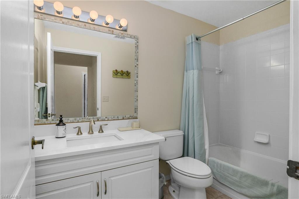 Full Guest bathroom with vanity, shower / bath combination with curtain, toilet, and visible vents