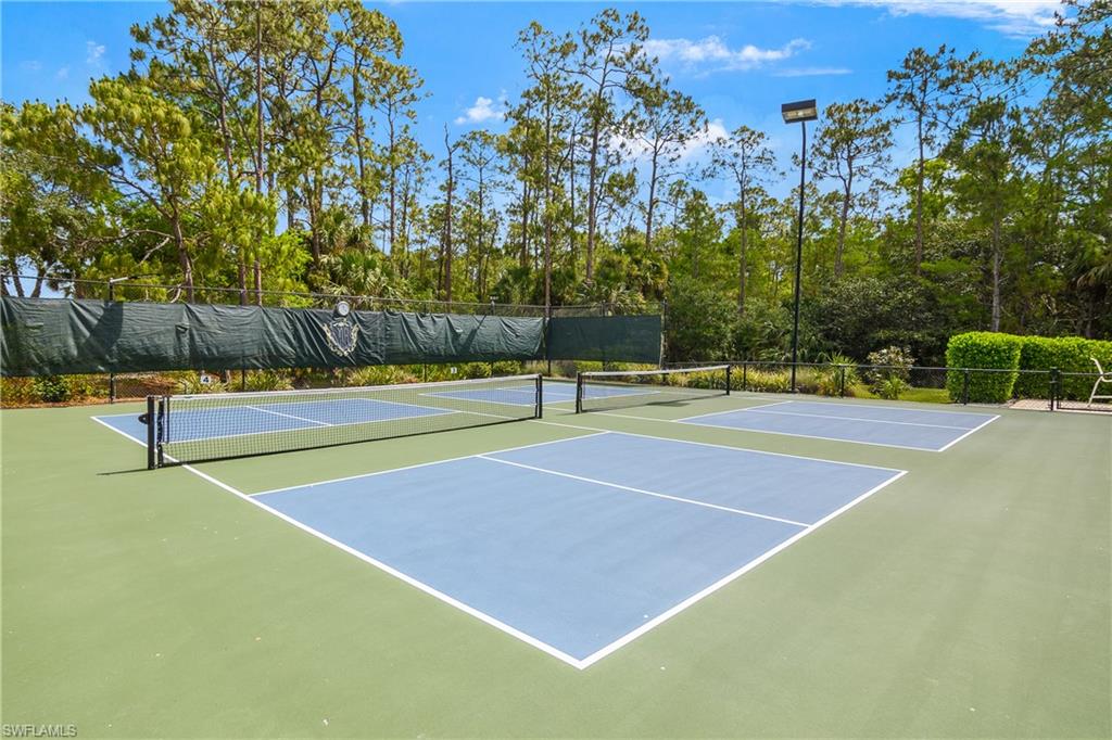 View of sport court featuring fence and community basketball court