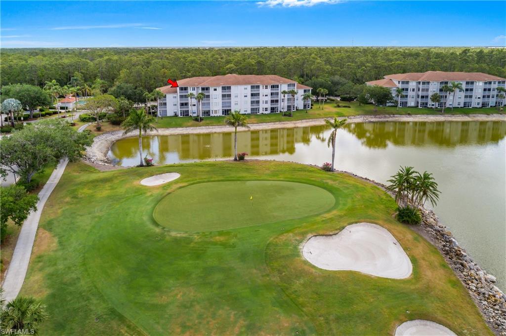Birds eye view of property with a water view and golf course view