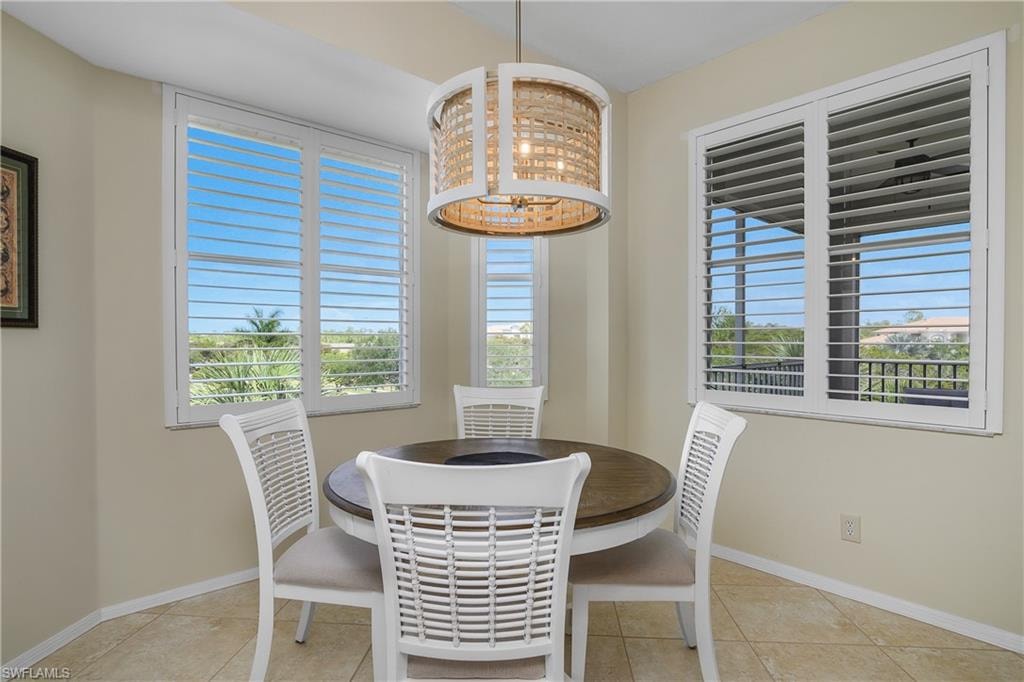 Dining area with tile patterned flooring and baseboards