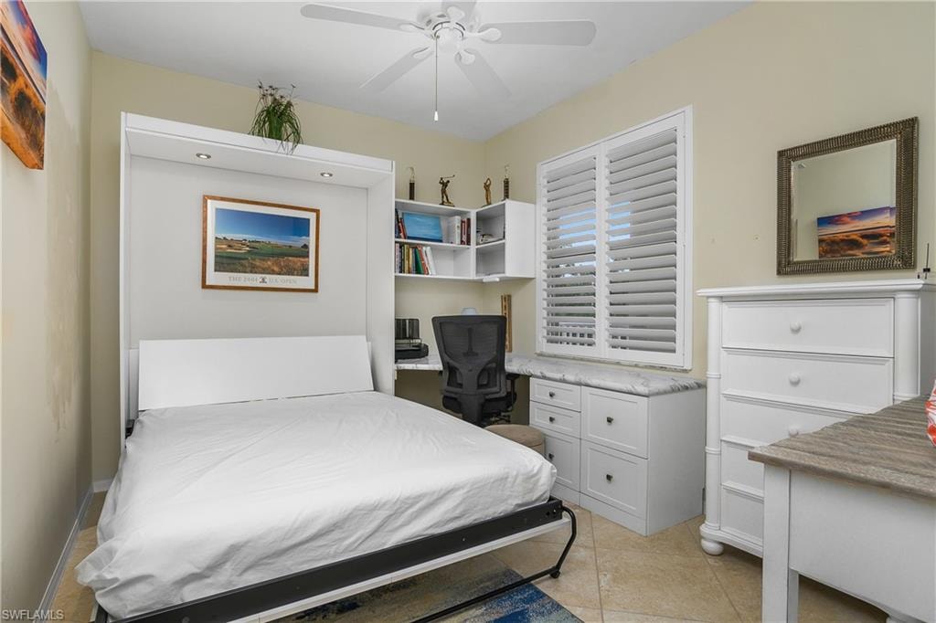 Bedroom featuring light tile patterned floors and a ceiling fan