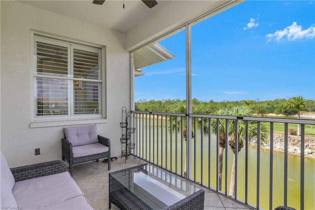 Balcony with a water view and ceiling fan