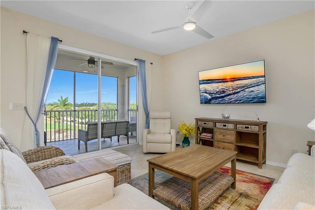 Living area with a ceiling fan and light tile patterned floors