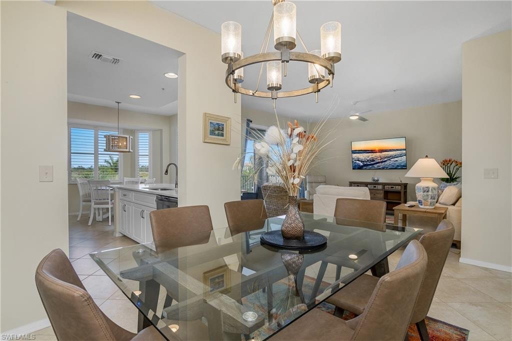 Dining space featuring visible vents, an inviting chandelier, light tile patterned flooring, baseboards, and recessed lighting