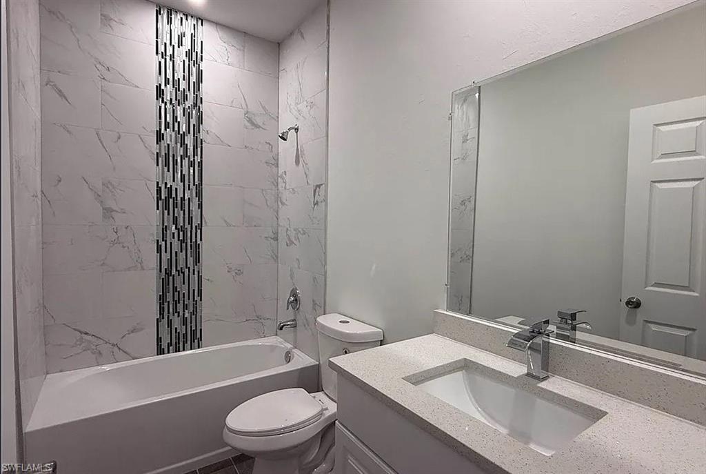 Bathroom featuring vanity and shower / tub combination