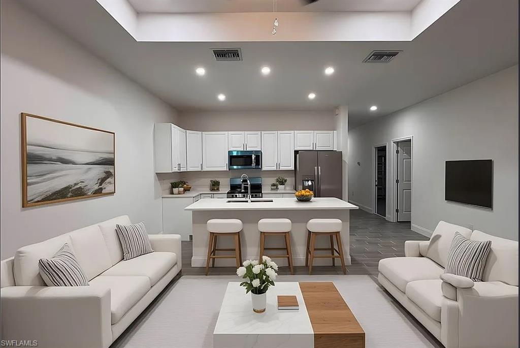 Living room featuring light wood-style floors and recessed lighting