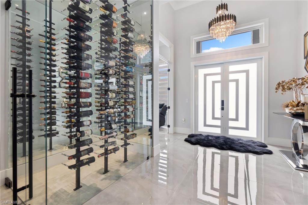 Wine area with baseboards and a chandelier