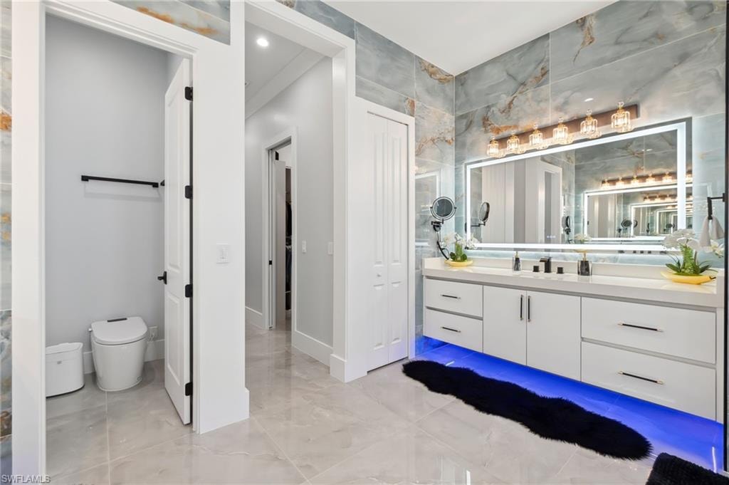 Full bathroom featuring vanity and toilet