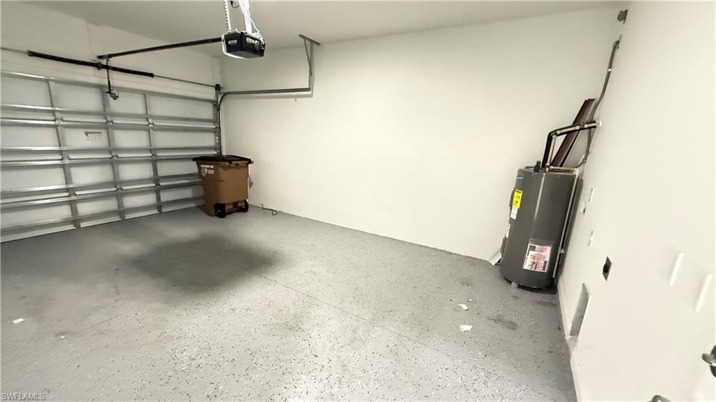 Garage featuring water heater and a garage door opener