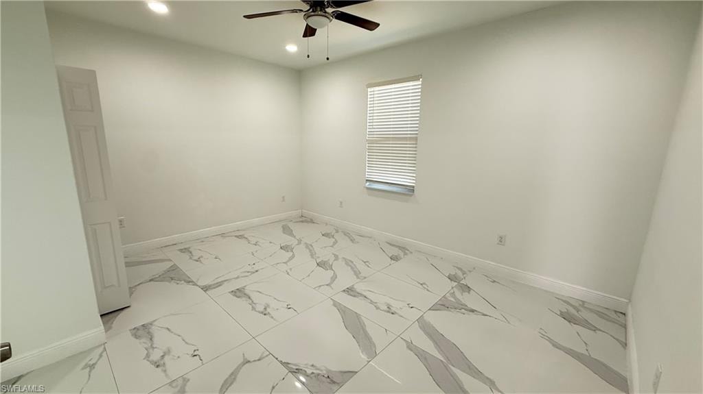 Unfurnished room with recessed lighting, light marble finish floors, and a ceiling fan