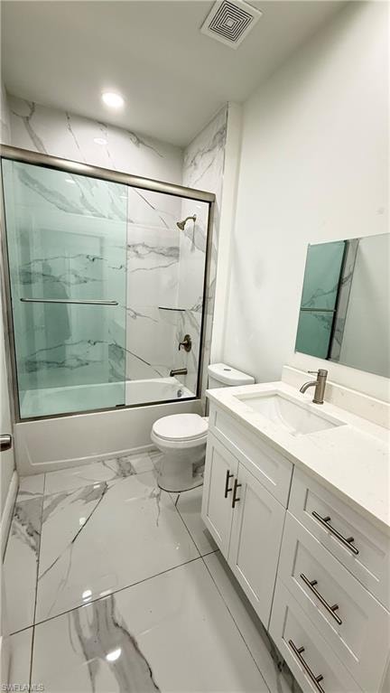 Full bath featuring vanity, bath / shower combo with glass door, and light marble finish flooring