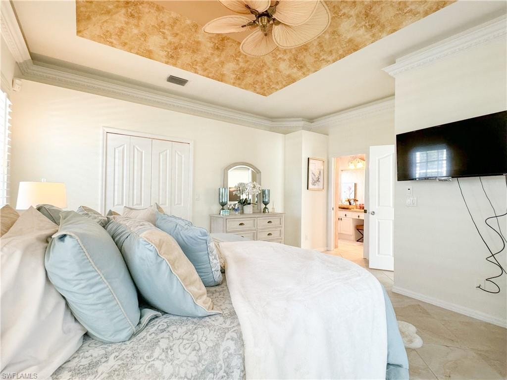 Bedroom featuring ornamental molding, a closet, light tile flooring, and ceiling fan