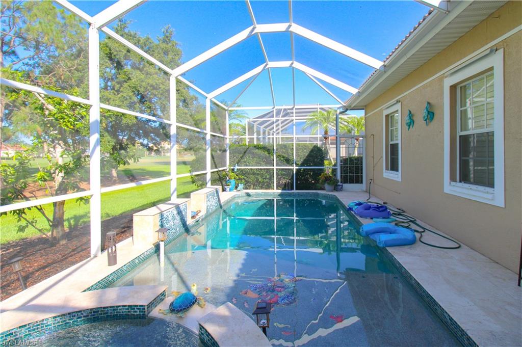 View of swimming pool featuring a patio, a lanai, and a lawn