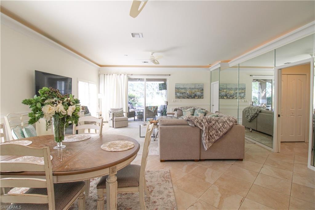 Tiled dining space featuring ceiling fan