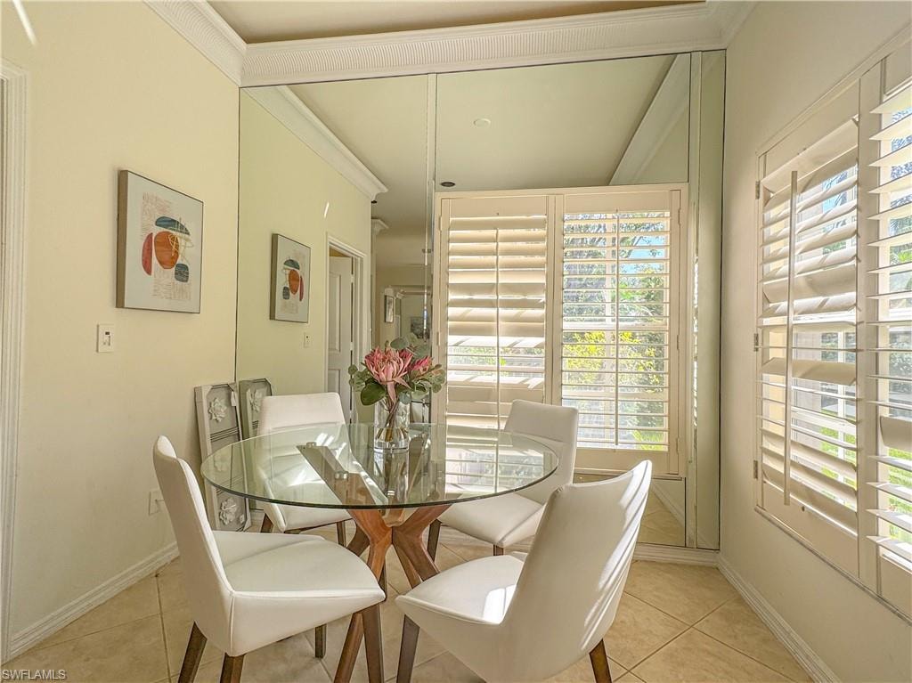 Dining area featuring vaulted ceiling and light tile floors