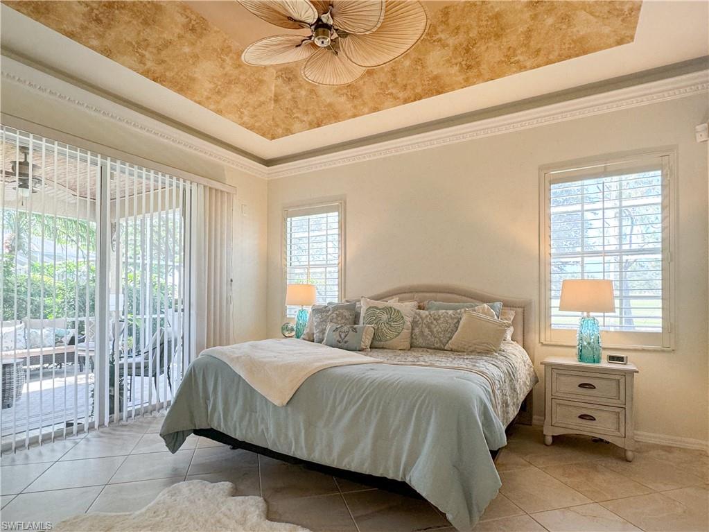 Bedroom with ceiling fan, access to exterior, and multiple windows