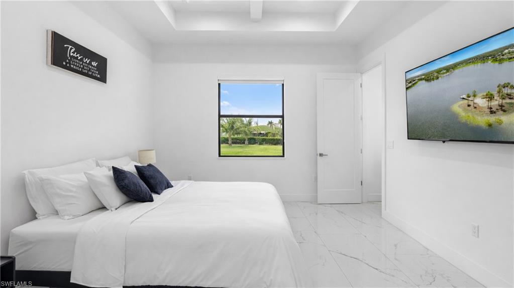 Bedroom with light marble finish floors and baseboards