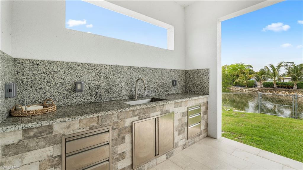 View of patio / terrace featuring exterior kitchen and a water view