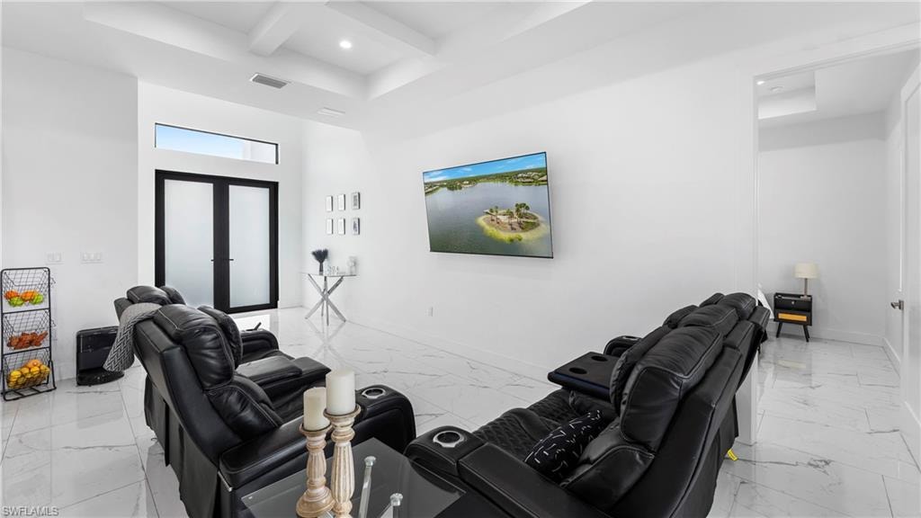 Living area with coffered ceiling, recessed lighting, french doors, and light marble finish floors