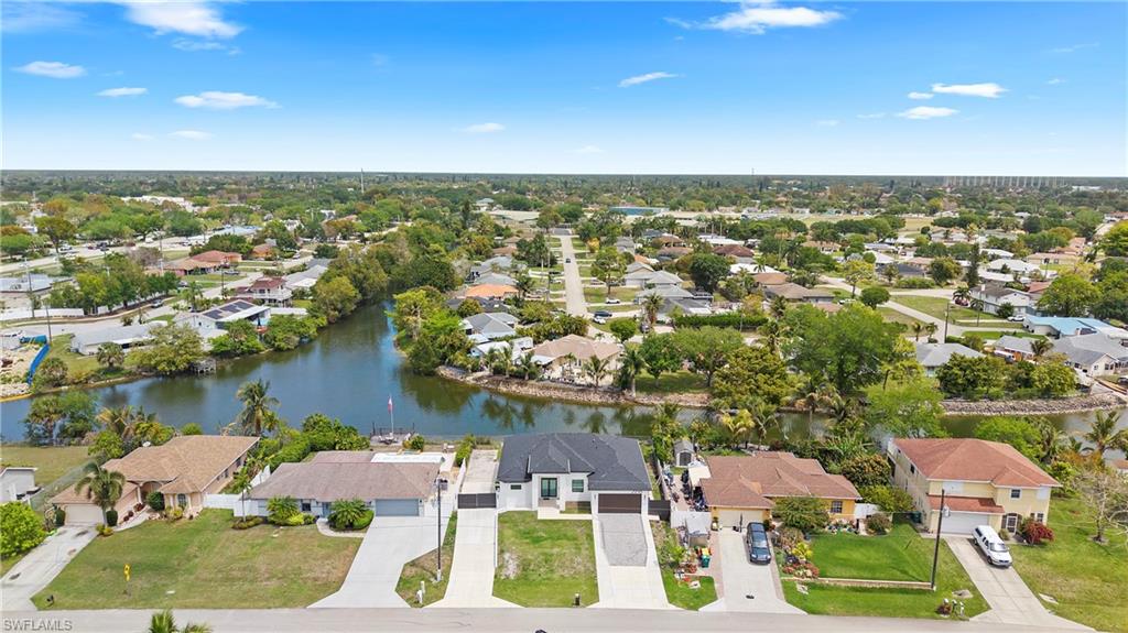 Aerial perspective of suburban area with a nearby body of water