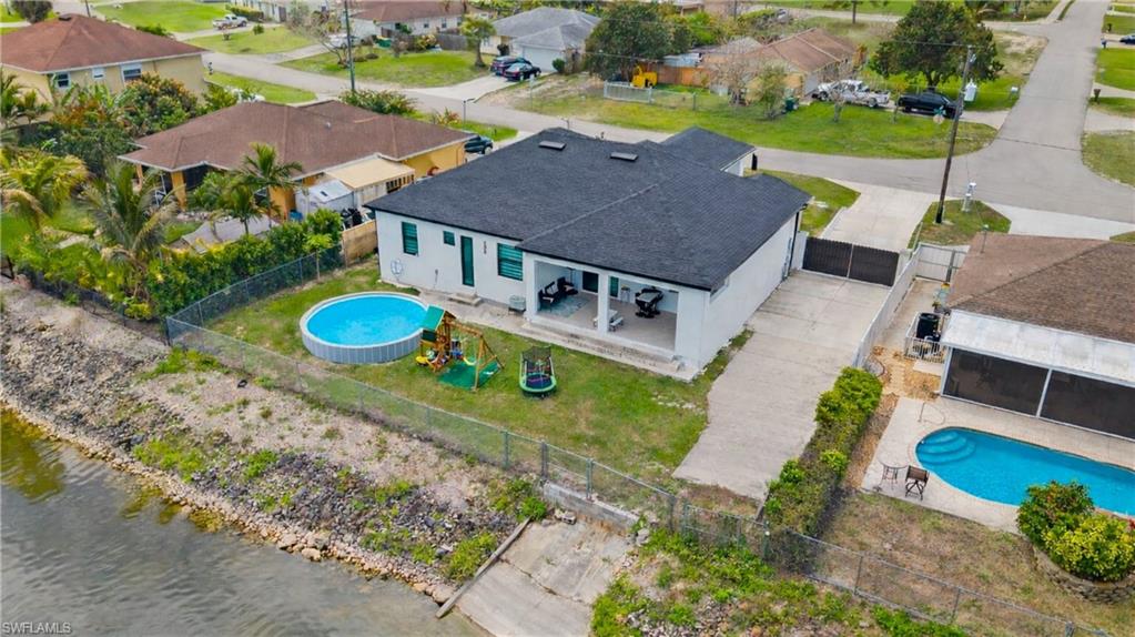 Aerial view of residential area featuring a pool area