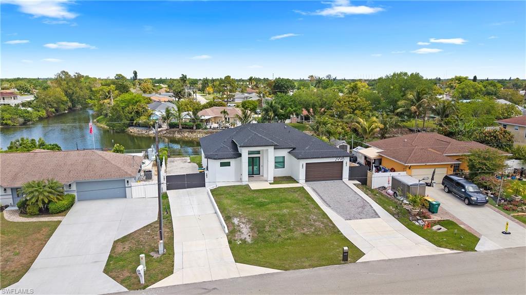 Aerial perspective of suburban area featuring a tree filled landscape and a large body of water