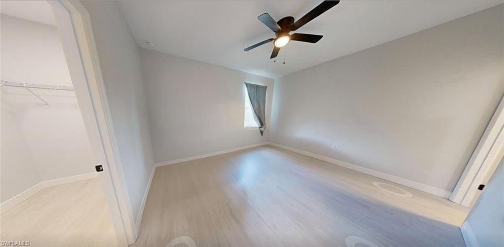 Unfurnished bedroom featuring light wood-type flooring and a ceiling fan