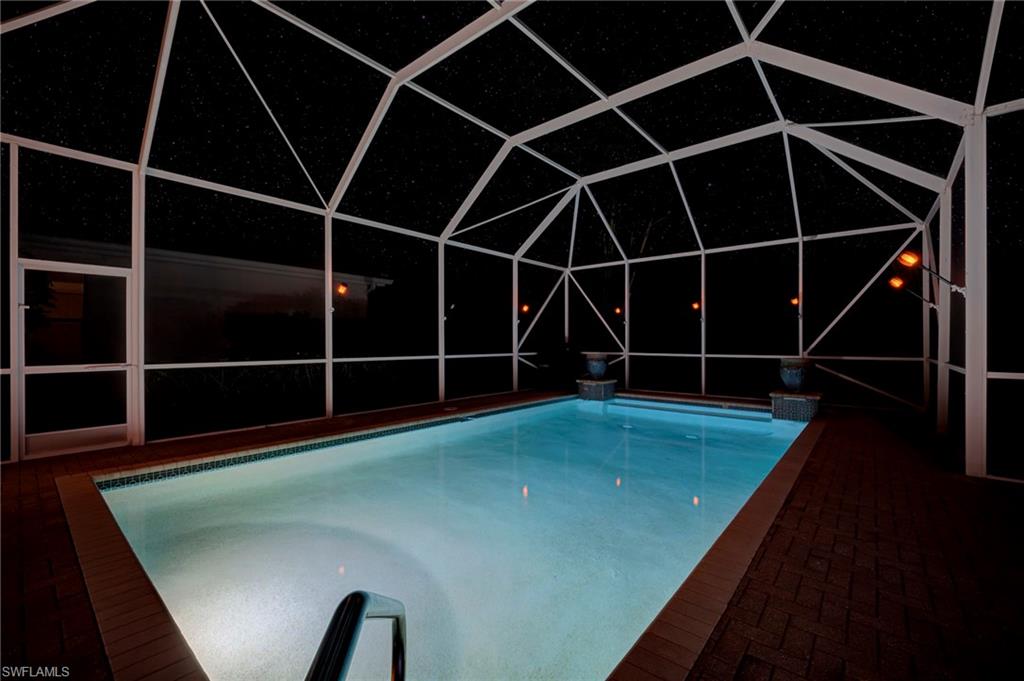 Pool at twilight featuring an outdoor pool, and enclosure