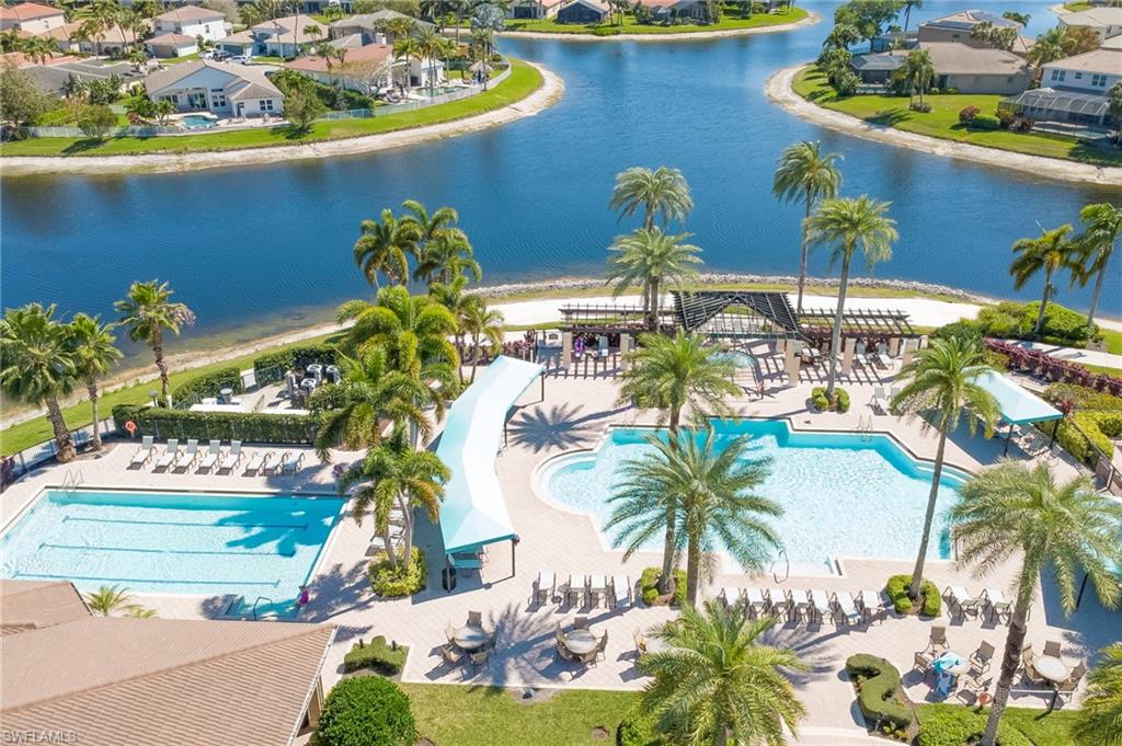 Community pool featuring a residential view, a water view, and a patio