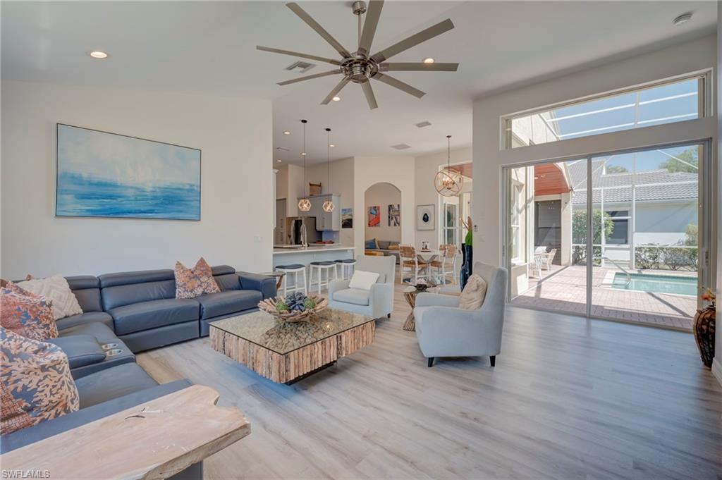Living area featuring ceiling fan, light wood-style flooring, and recessed lighting