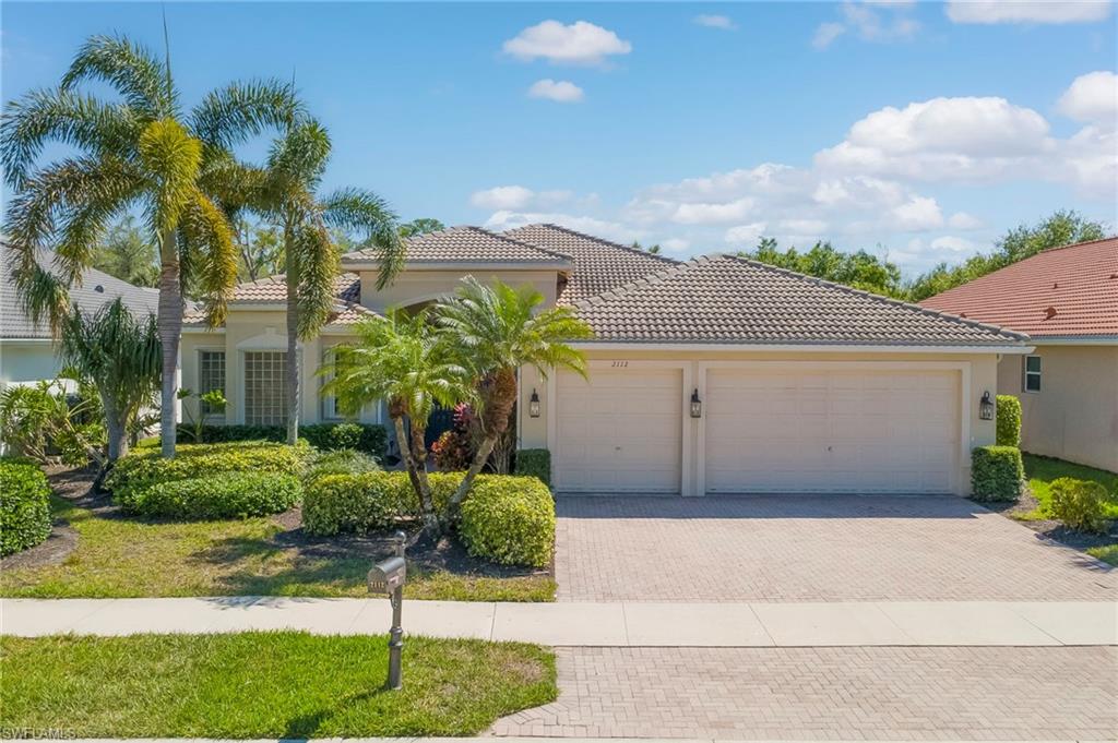 View of front of property with an attached garage, decorative driveway, stucco siding, and a tile roof