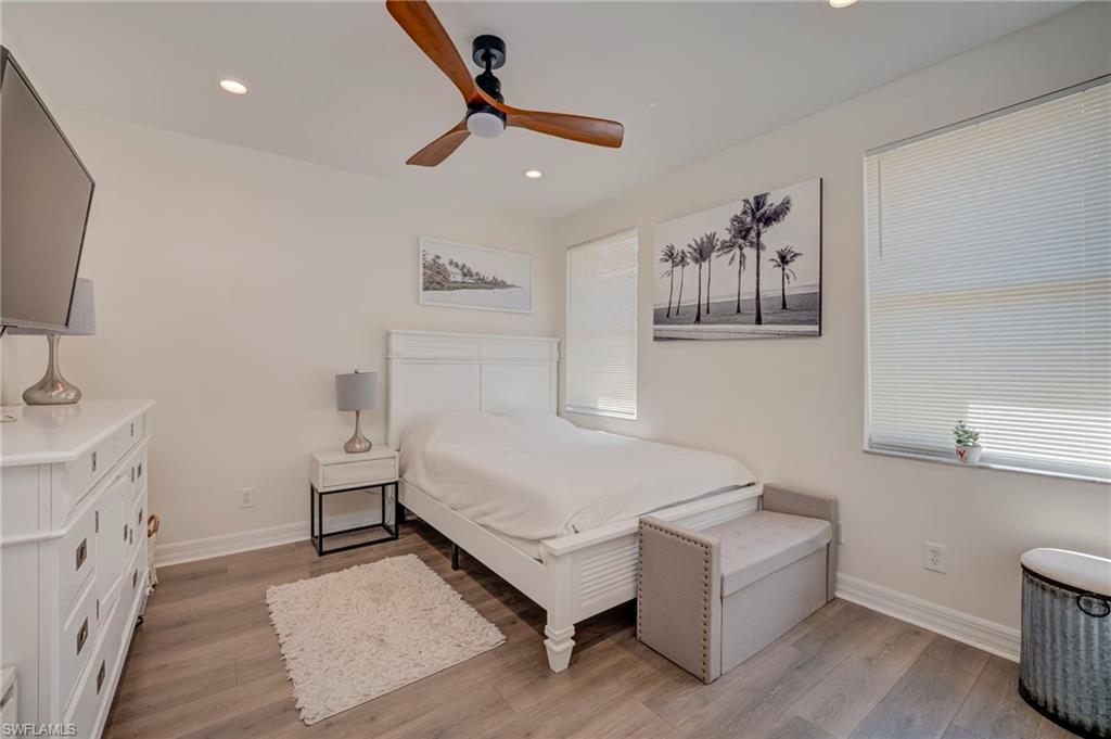Bedroom featuring light wood finished floors, ceiling fan, and recessed lighting