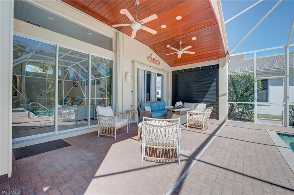 View of patio / terrace featuring enclosure, an outdoor pool, an outdoor lounge area, and ceiling fan