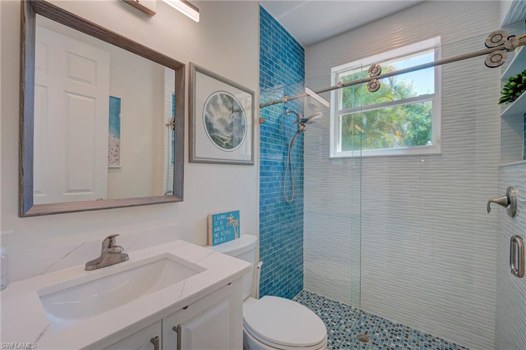 Bathroom featuring vanity and a stall shower