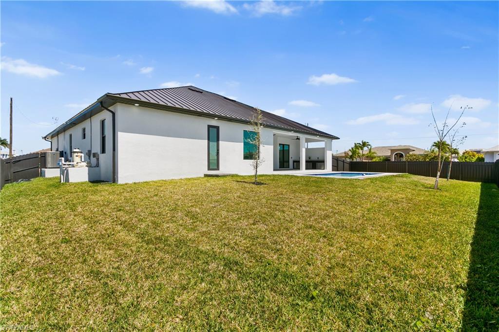 Spacious backyard offers plenty of room for a boat, trailer, or to create your own tiki retreat while providing ample space for pets to run and entertain outdoors.