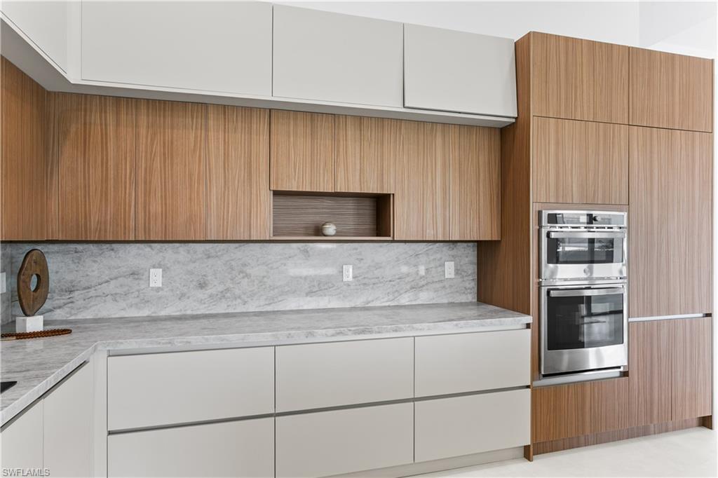 Large pantry & premium GE appliances including wall oven, microwave, electric cooktop, dishwasher, refrigerator and freezer, plus a large sink with black fixtures