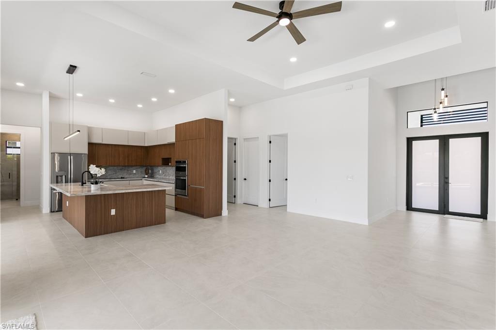 High-end finishes include MATTE PORCELAIN TILE throughout, IMPACT-RESISTANT Low-E windows & doors, BAHAMA SHUTTERS &  a welcoming COLUMNED FRONT PORCH w/ frosted DOUBLE ENTRY DOORS.