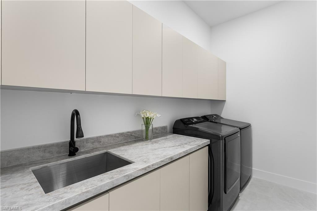 SPACIOUS LAUNDRY w/ SAMSUNG washer & dryer, built-in cabinetry, folding marble counter & utility sink