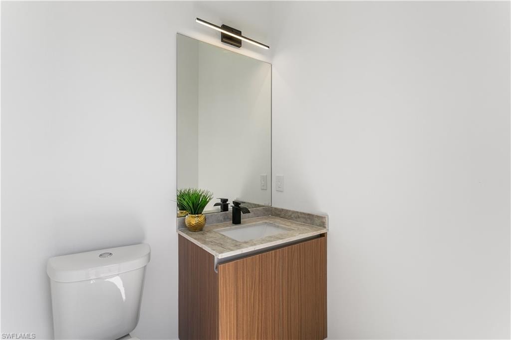 Convenient cabana half bathroom provides easy access from the pool area, perfect for guests and outdoor entertaining.