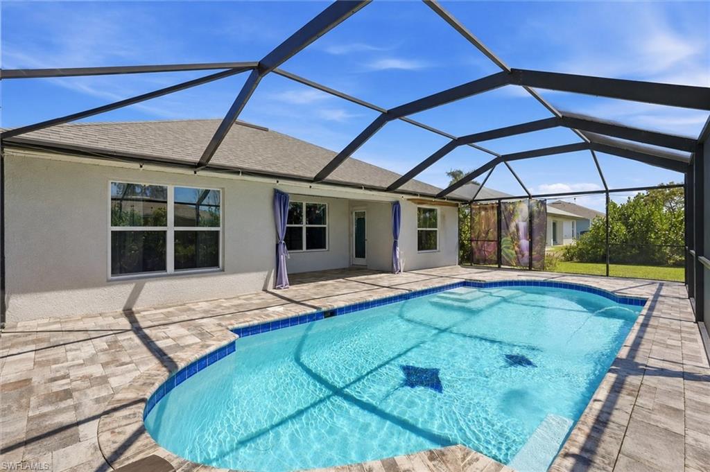 Ranch-style home with an attached garage, concrete driveway, stucco siding, and a shingled roof