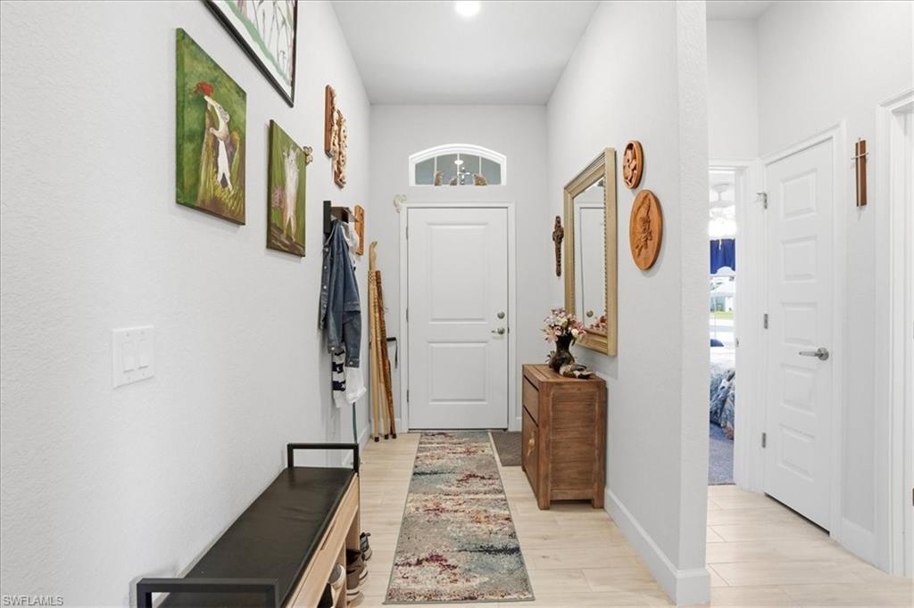 Laundry area featuring separate washer and dryer and baseboards