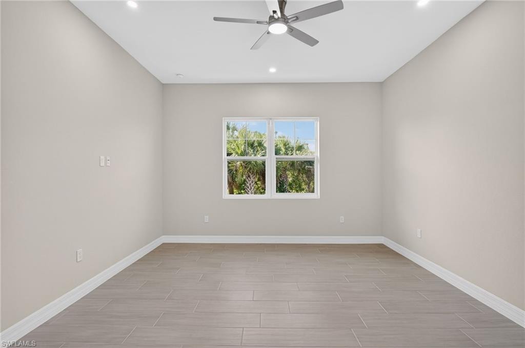 Spare room with ceiling fan, wood tiled floors, and recessed lighting