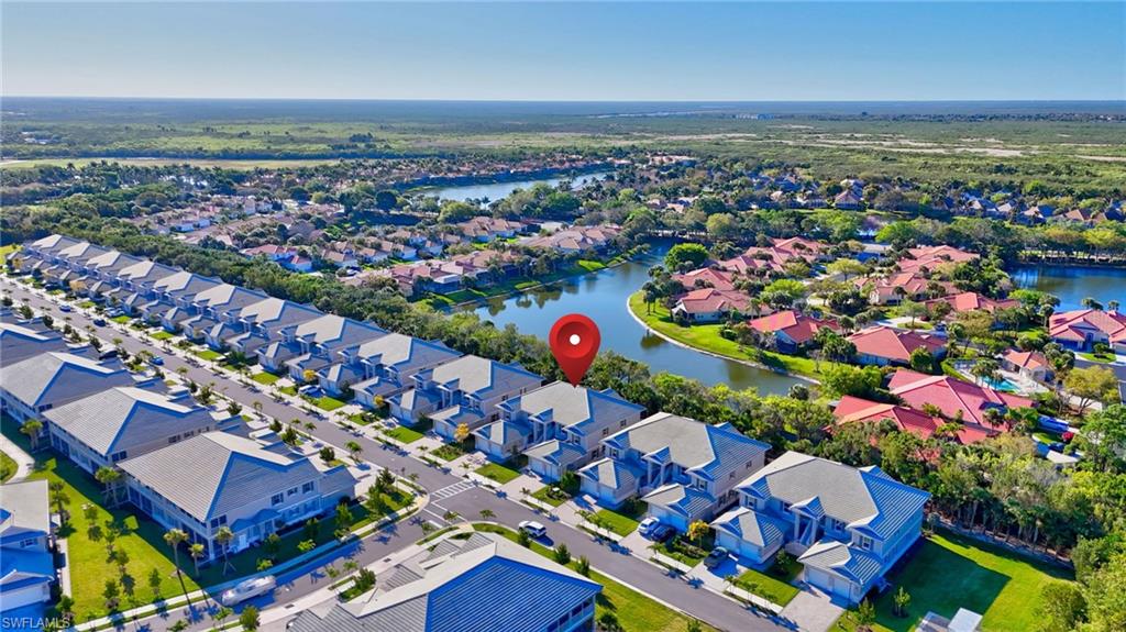 Aerial view of property and surrounding area with nearby suburban area and a nearby body of water