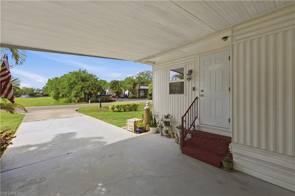 Covered carport with concrete flooring and direct access to the entry door