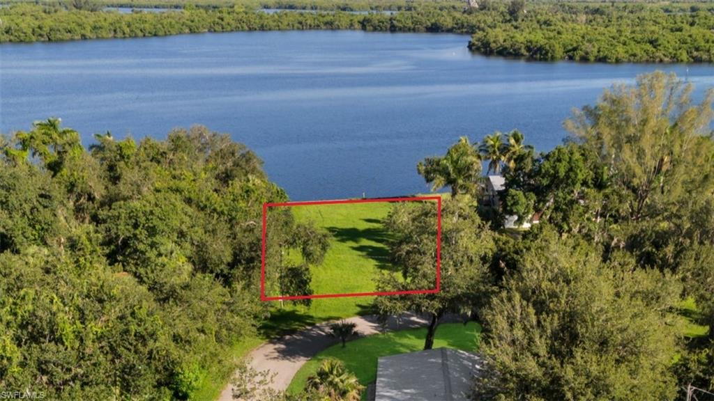 Aerial overview of property's location featuring property boundaries highlighted and a nearby body of water